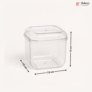 A clear plastic square container with a matching lid, shown on a light beige background with black dimension arrows and labels indicating 7.5 cm on each side.