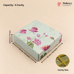 A square bakery box with a light green floral print featuring pink lotus flowers, shown with dimension arrows indicating 12 cm by 12 cm by 3.5 cm (4.
