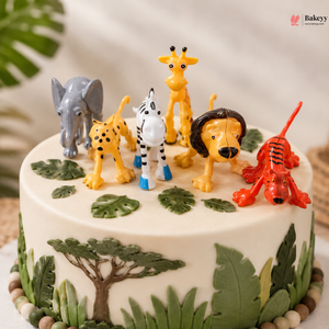 Cake with animal figurines on a white background