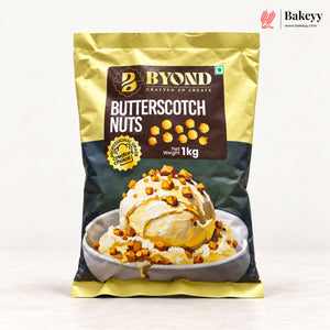 A 1 kg bag of Byond Butterscotch Nuts, featuring a gold and dark green packaging design with a central brown label and an image of an ice cream dessert topped with nuts. The Bakeey brand logo is visible in the top right corner.