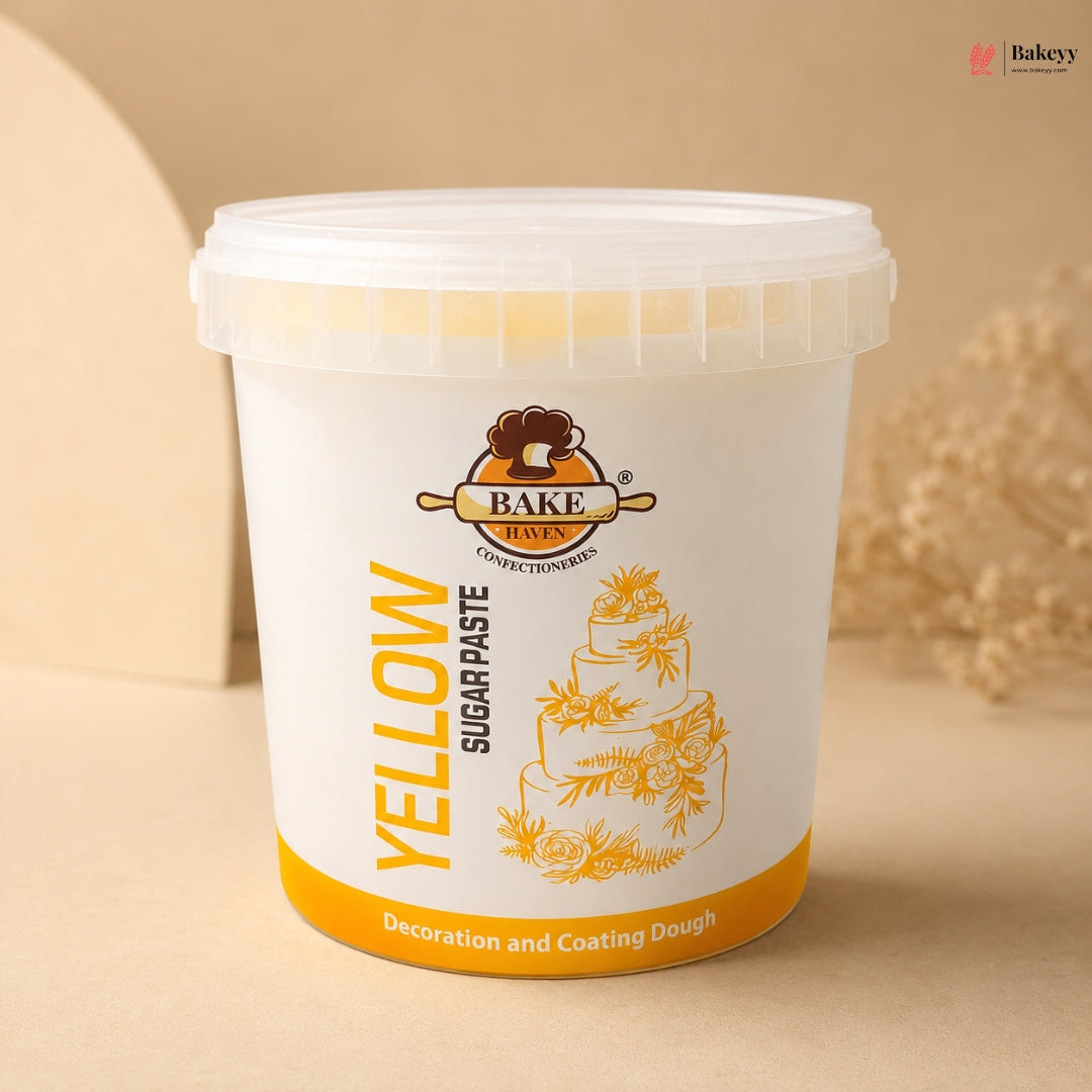 White container of yellow sugar paste with a cake illustration on a beige background