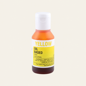 A bottle of Yellow Oil Based Food Colouring with a white cap, featuring a white and yellow label, set against a solid off-white background.