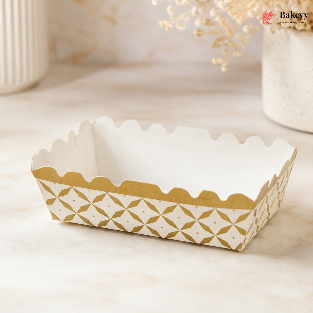 White paper tray with gold geometric pattern on a light surface, featuring the brand 'Bakey'.