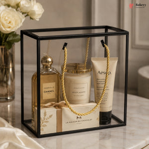 Gift set with Chanel perfume, candle, and Aesop hand cream in a decorative box.