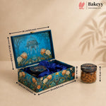An ornate blue decorative gift box with floral artwork and a matching round tin inside, shown open with dimension arrows indicating measurements. A small jar of almonds sits beside it on a beige background with shadow overlays.