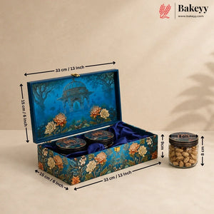 Decorative rectangular gift box with illustrated blue floral and architectural artwork, shown open with two round jars inside and a separate jar beside it. Black dimension arrows label the box measurements as 33 cm / 13 inch, 15 cm / 6 inch, and 8 cm / 3 inch.