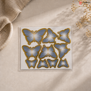 Butterfly-shaped decorative stickers on a beige surface with a soft focus background