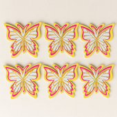 Set of six butterfly-shaped decorations with pink, yellow, and white colors on a beige background.