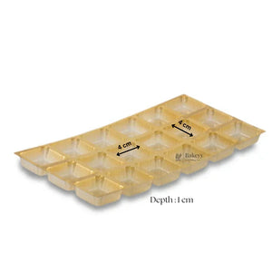 Gold plastic chocolate mould tray with 16 square cavities, each 4 cm, depth 1 cm, Bakeyy.com.