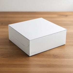 Bakeyy plain white cake box on a wooden table, ideal for bakery packaging and gifting