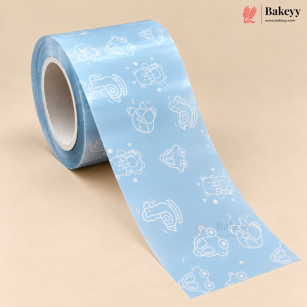 A roll of light blue tape with a repeating white outline pattern of cartoon characters, shown on a beige background with the Bakeyy brand logo in the top right.