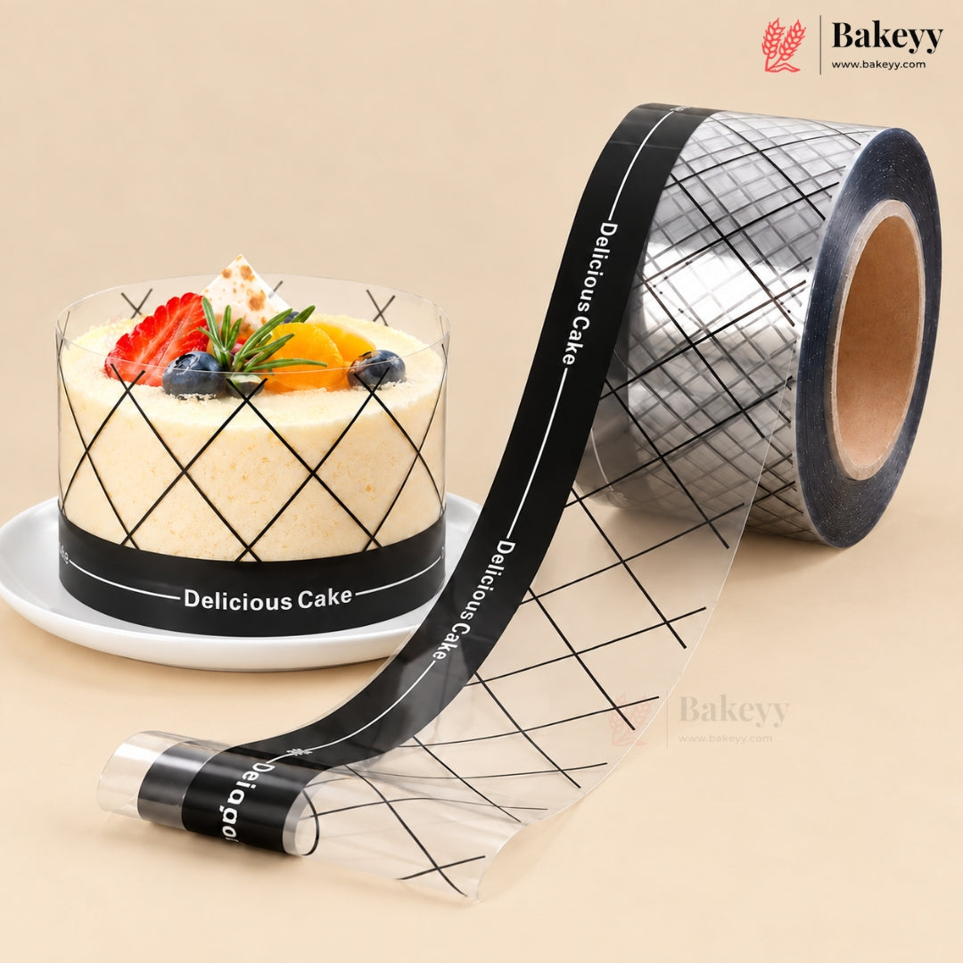 A roll of clear bakery tape with a black grid pattern and white 'Delicious Cake' text, shown next to a decorated cake on a white plate. The Bakeyy brand logo is visible in the top right corner.