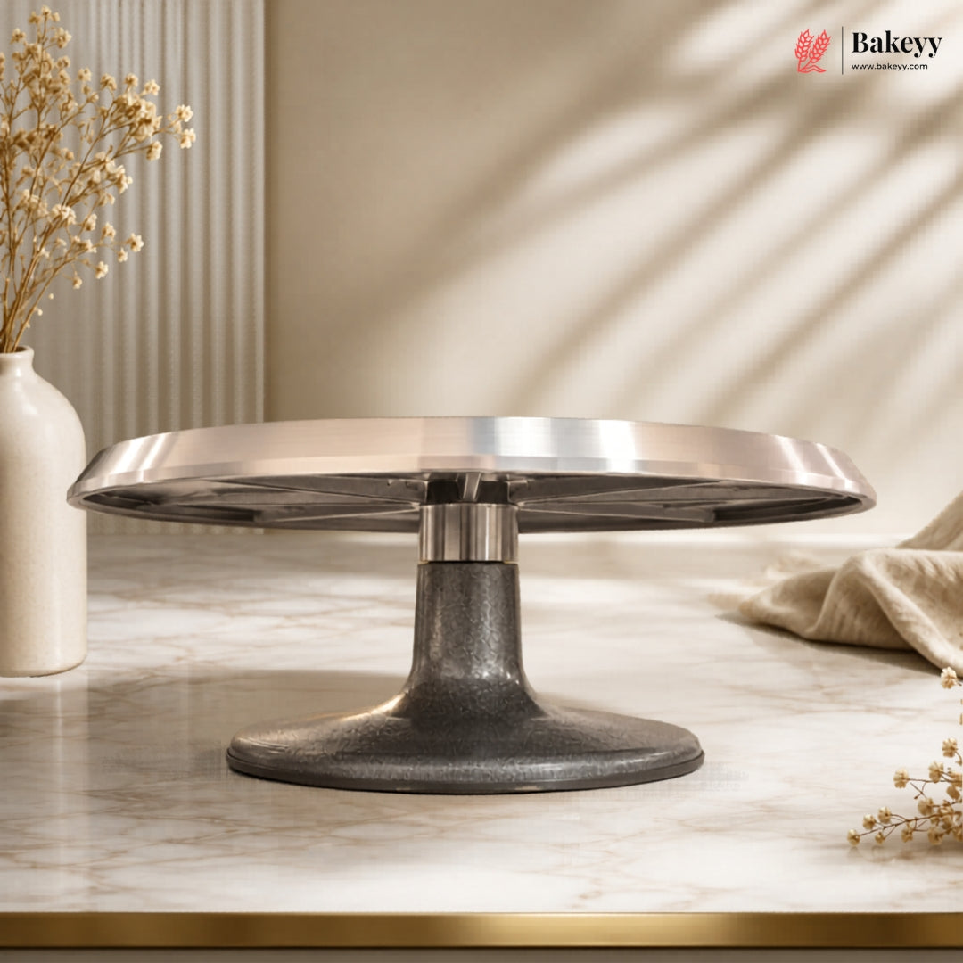 Metallic cake stand on a marble surface with a neutral background