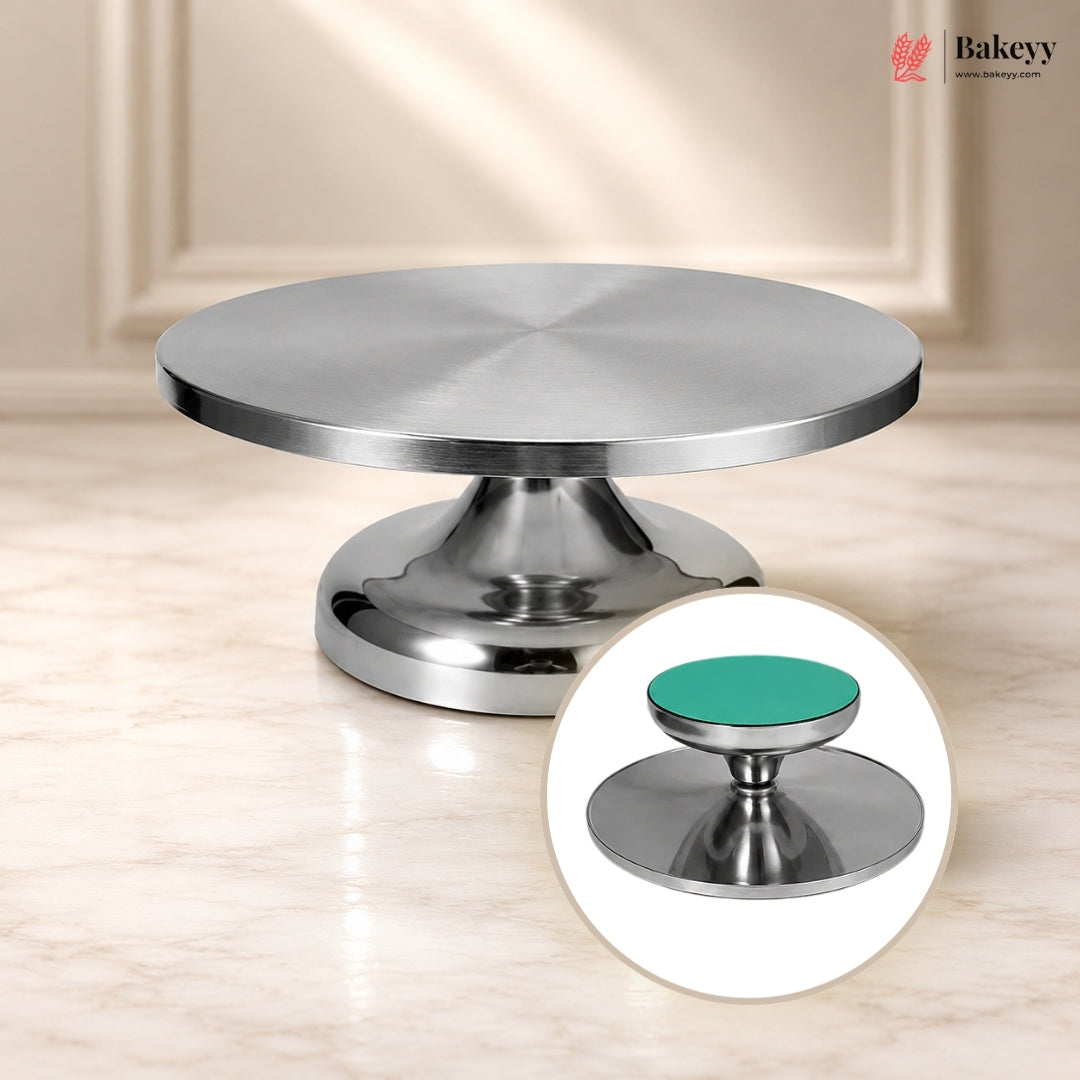Metallic cake stand with a green base on a beige surface, featuring the Bakey brand.