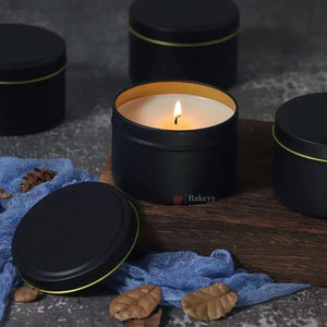 Black metal candle tin boxes with gold rims, one lit, on Bakeyy.com for gift packaging