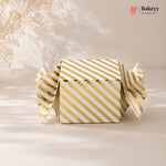 Gold and white striped box with 'Bakeyy' branding on a beige background