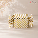 Gold and white striped box with 'Bakeyy' branding on a beige background