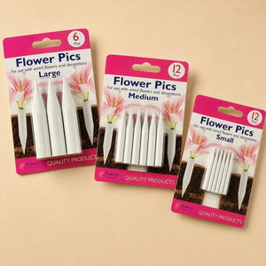 Three packaged sets of white flower picking tools labeled Large, Medium, and Small, shown on a plain beige background. Each set is in a pink and white card package with the text 'Flower Pics' and 'Bakery'.