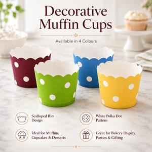 Decorative muffin cups in red, green, blue, and yellow with scalloped rim and white polka dot pattern on a marble surface.
