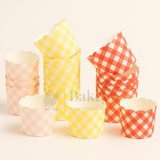Set of colorful checkered cupcake liners on a light beige background