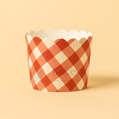 Red and white checkered cupcake wrapper on a beige background