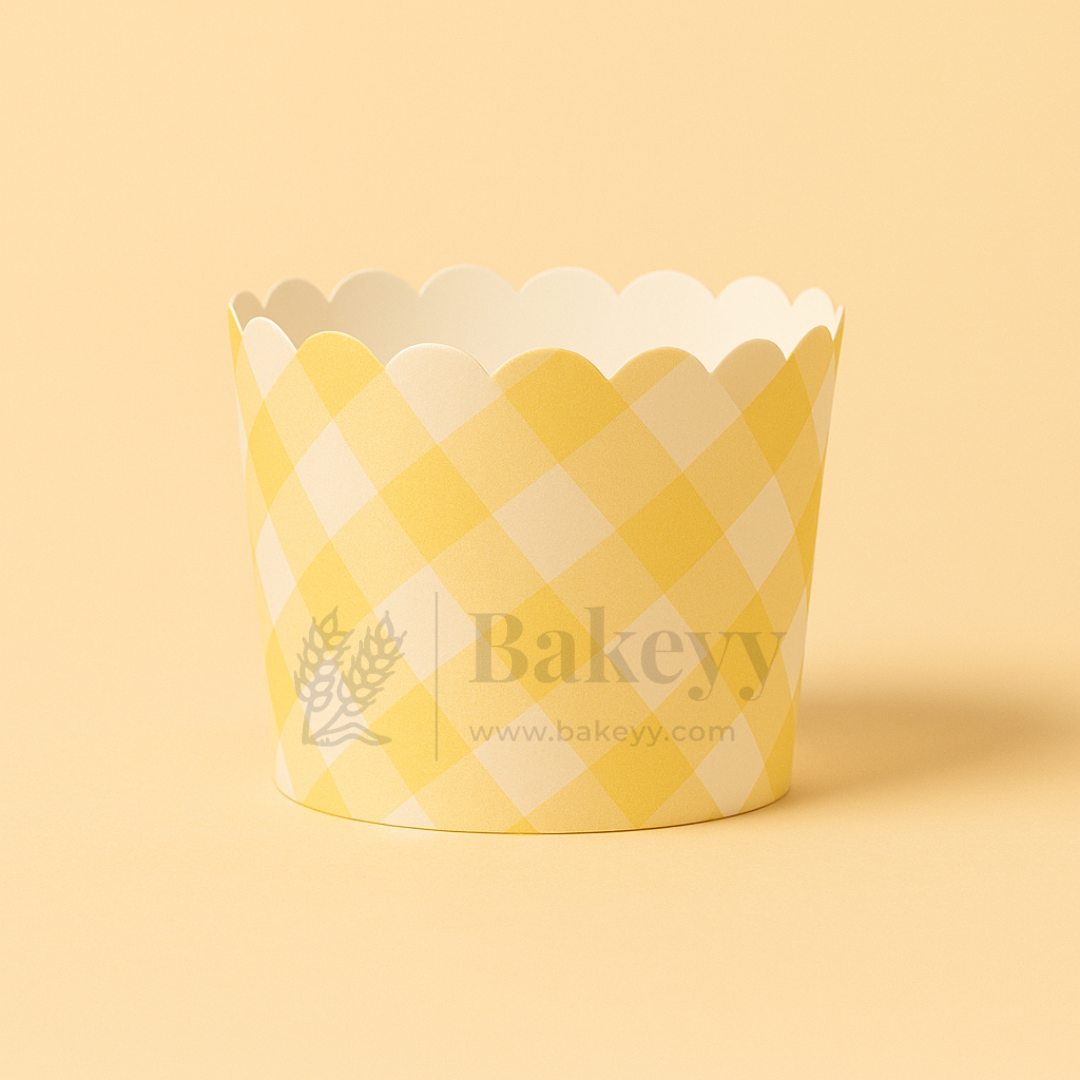 Yellow and white checkered cupcake wrapper with 'Bakeyy' branding on a beige background