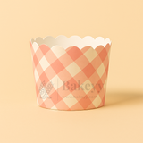 Checkered cupcake wrapper with scalloped edge on a beige background