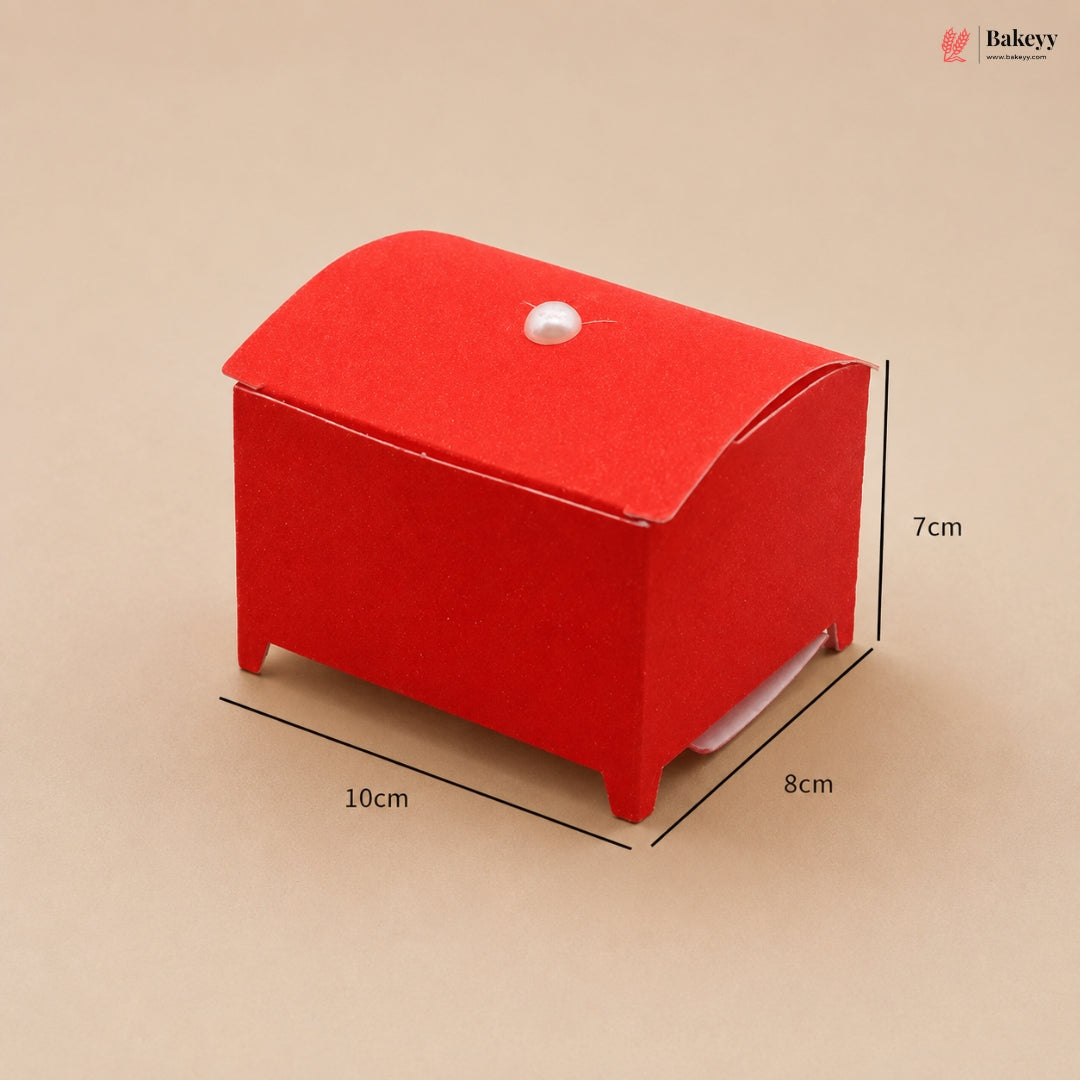 Red cardboard box with dimensions on a beige background