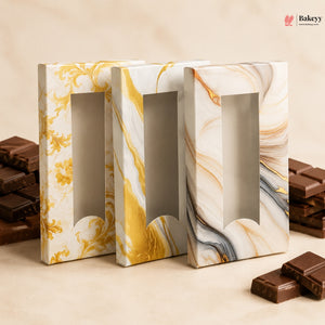 Marble-patterned chocolate boxes with chocolate bars on a beige background