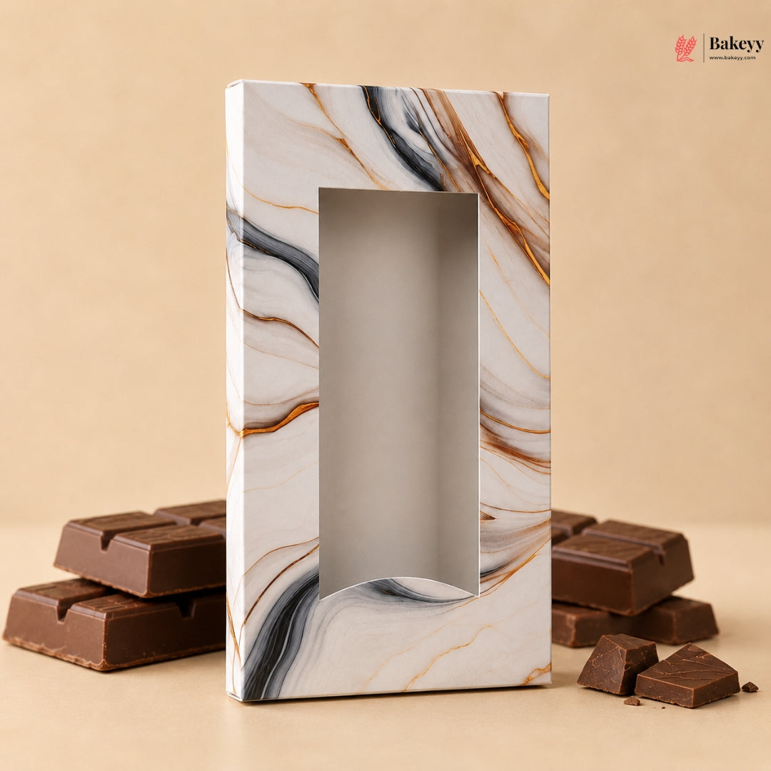 Marble-patterned chocolate box with chocolate bars on a beige background
