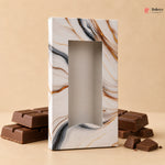 Marble-patterned chocolate box with chocolate bars on a beige background