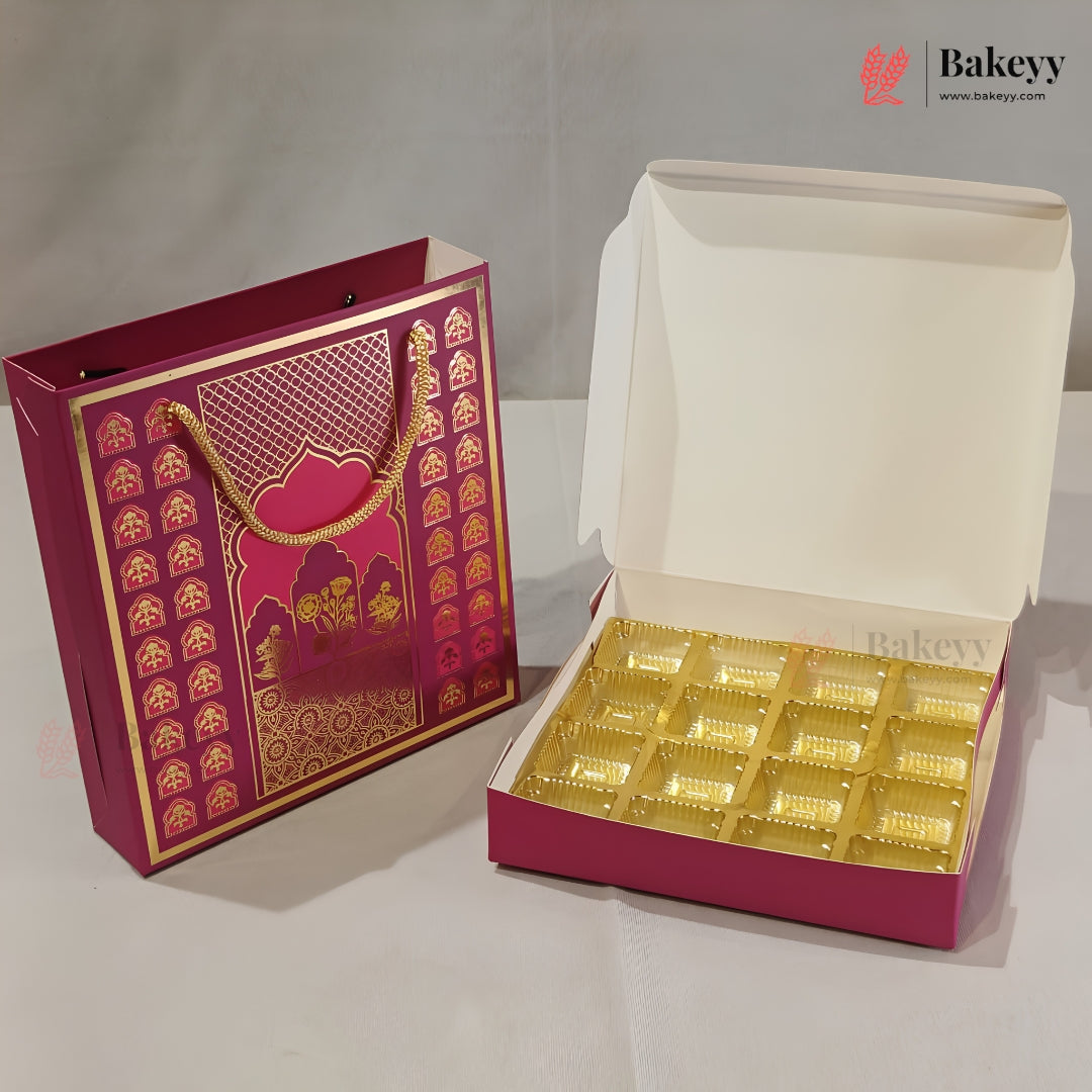 A magenta and gold decorative gift box set shown on a light gray surface, with one closed box featuring ornate gold patterns and one open box displaying multiple compartments lined with gold tissue paper. A Bakeyy watermark/logo appears in the top right.