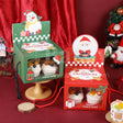 Christmas-themed cupcake boxes with Santa Claus design on a red background