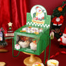 Christmas-themed display stand with snowman design and cupcakes on a red background