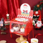Red Christmas-themed cupcake box with cupcakes on a stand against a festive background.