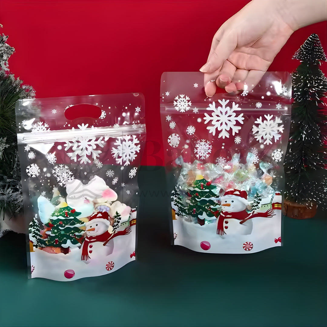 Two Christmas-themed clear bags with snowflakes and snowmen on a red and green background.