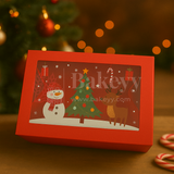 Red Christmas-themed gift box with a snowman, tree, and reindeer design, featuring the brand 'Bakeyy'.
