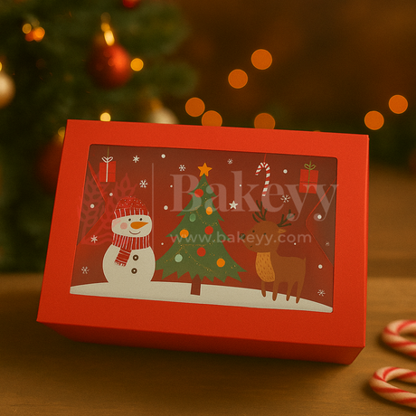 Red Christmas-themed gift box with a snowman, tree, and reindeer design, featuring the brand 'Bakeyy'.