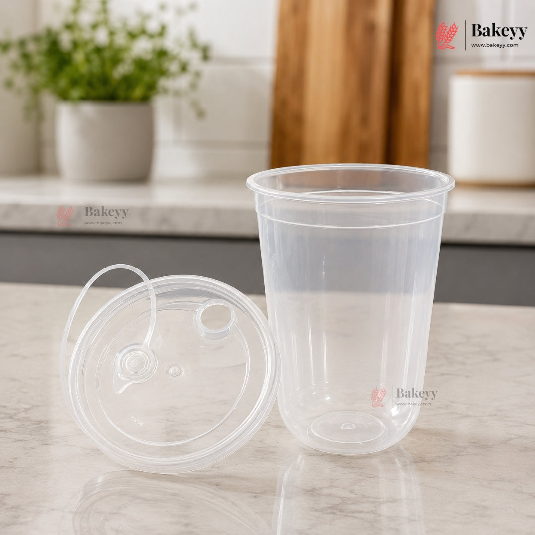Clear plastic cup with lid on a marble surface, with 'Bakeyy' branding.