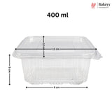 Clear plastic food storage container with lid, shown with dimension lines and text indicating 400 ml capacity and measurements of 13 cm length, 9 cm width, and 5 cm height on a white background. Bakeyy logo appears in the top right.
