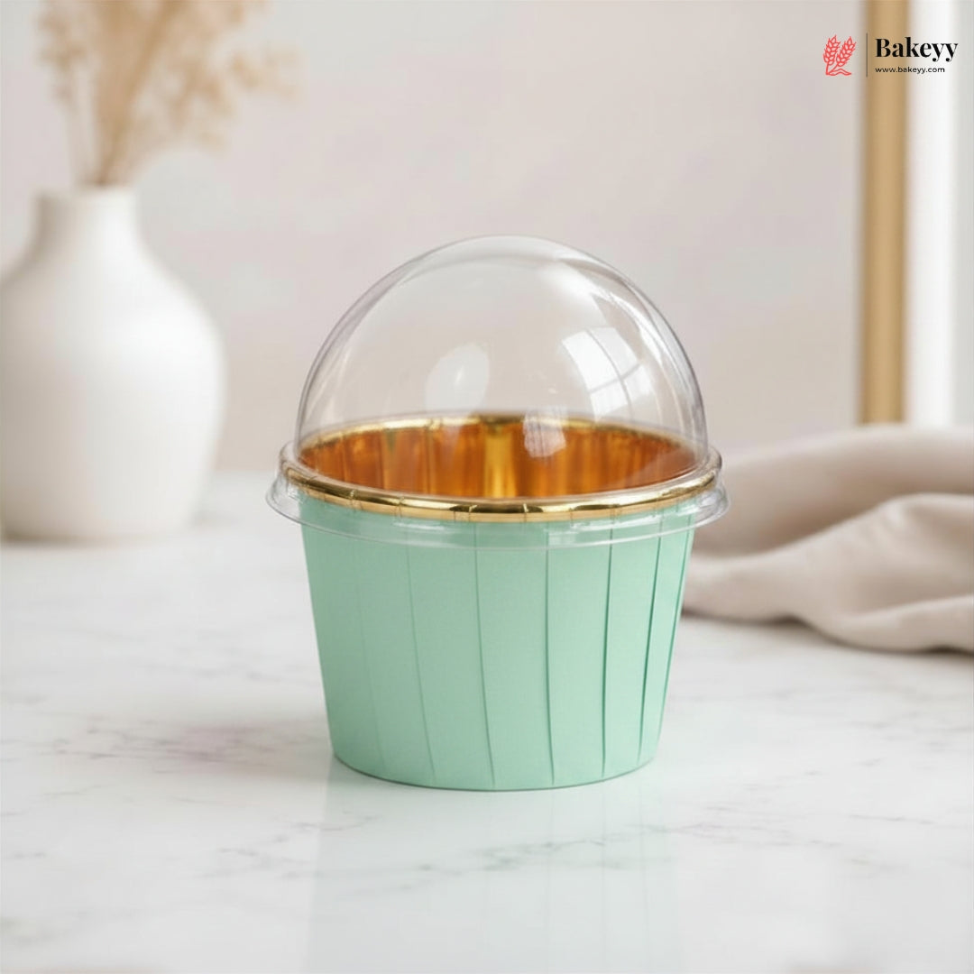 Green cupcake container with gold interior on a light surface, featuring the Bakey brand.