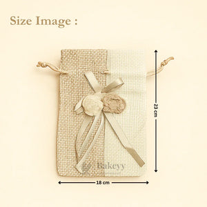 Bakeyy dual-tone jute gift bag with drawstring, ribbon bow, and pom-poms, 18x23cm size