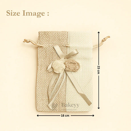 Bakeyy dual-tone jute gift bag with drawstring, ribbon bow, and pom-poms, 18x23cm size