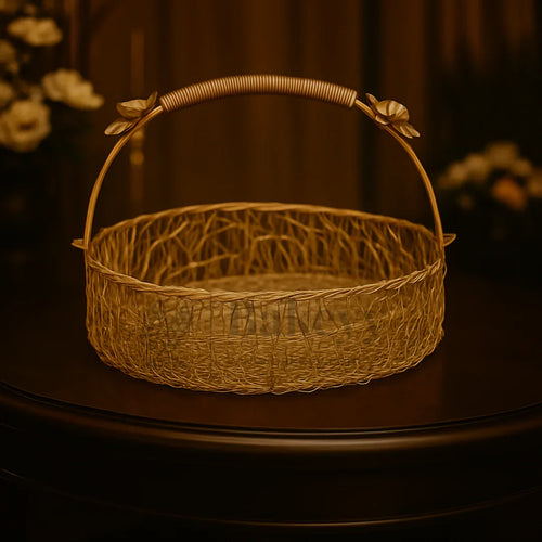 Decorative golden wire hamper basket with floral handle on a dark table, ideal for Bakeyy gift packaging and hamper making.