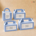 Four blue cardboard boxes with handle and customizable 'YOUR LOGO' label on a beige background.