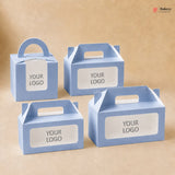 Four blue cardboard boxes with handle and customizable 'YOUR LOGO' label on a beige background.