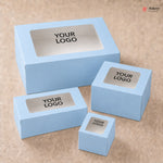 Set of light blue boxes with 'YOUR LOGO' text on a beige background