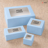 Set of light blue boxes with 'YOUR LOGO' text on a beige background