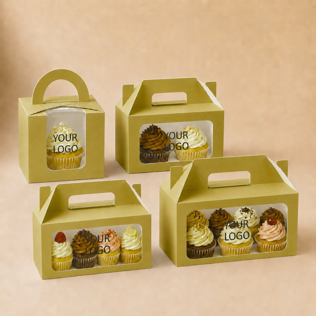 Four green cupcake boxes with clear windows displaying cupcakes on a beige background