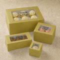 Set of yellow cake boxes with clear windows for displaying cupcakes on a beige background